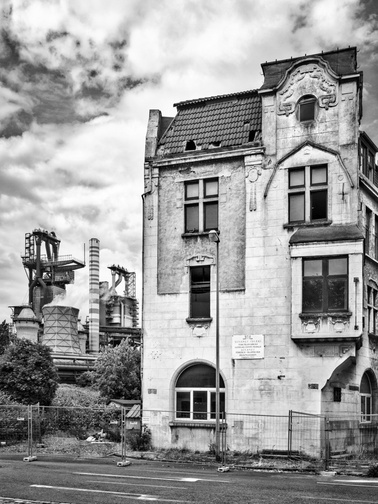Streetview in Duisburg-Bruckhausen with steelworks an furnaces in the background